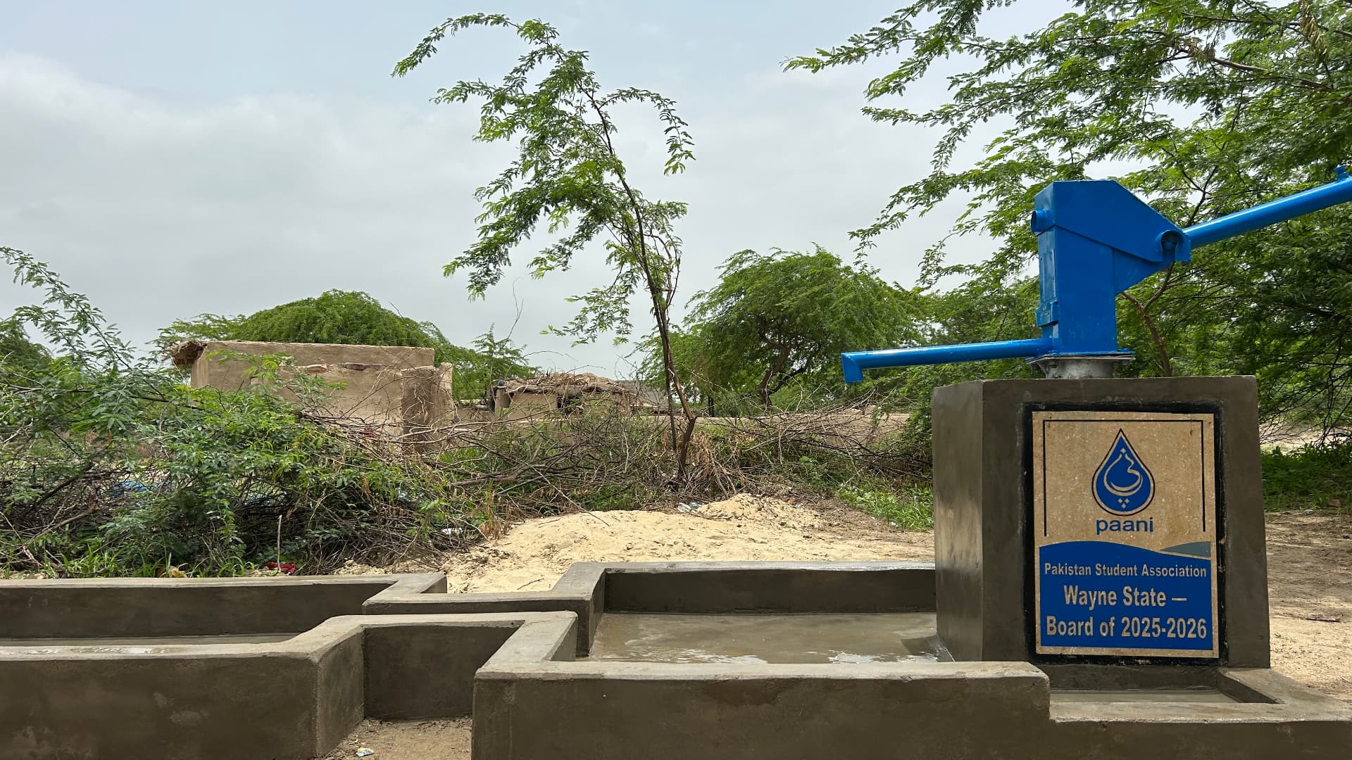 The finished well and PSA plaque in the Sindh village