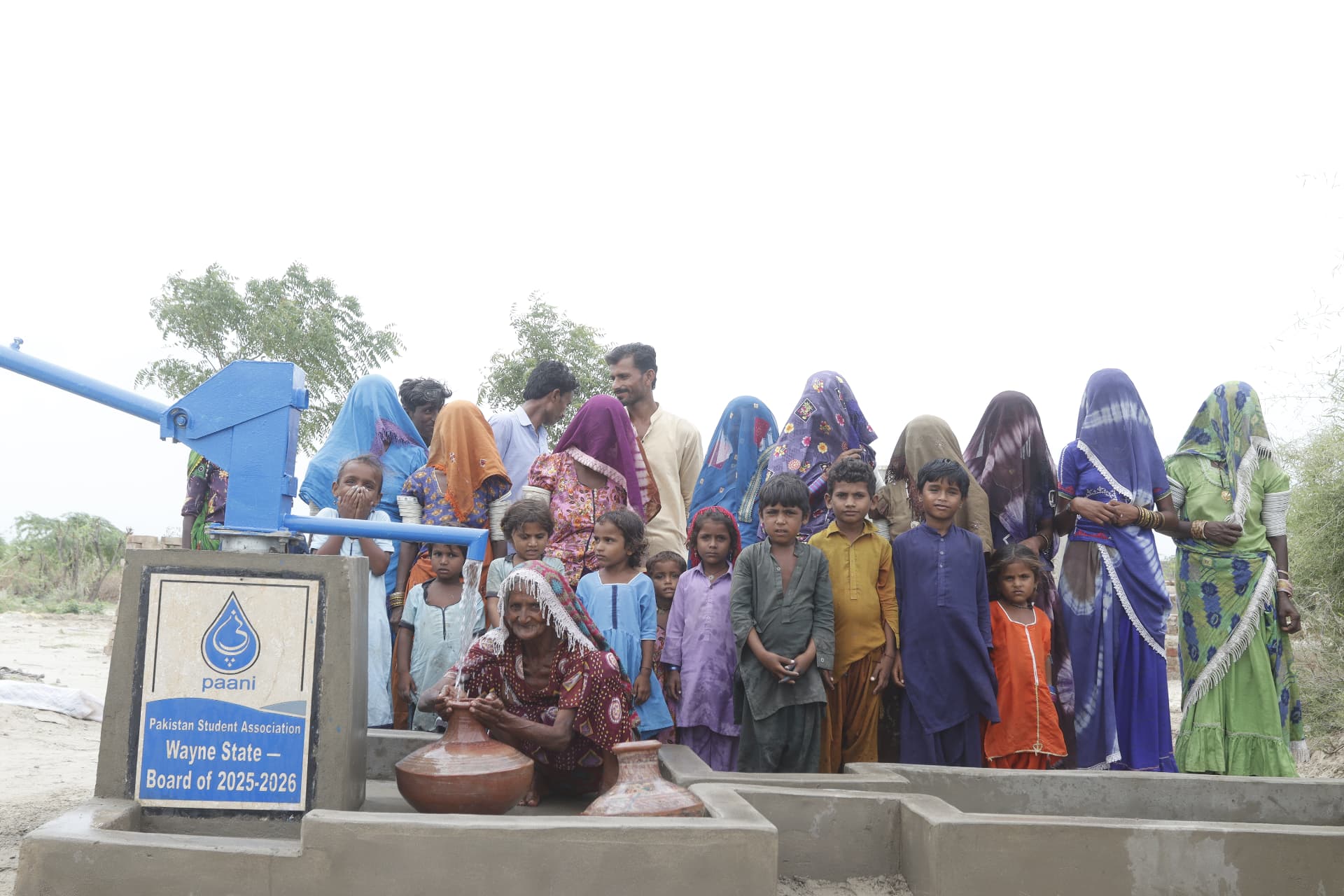 Children and families at the newly built water well