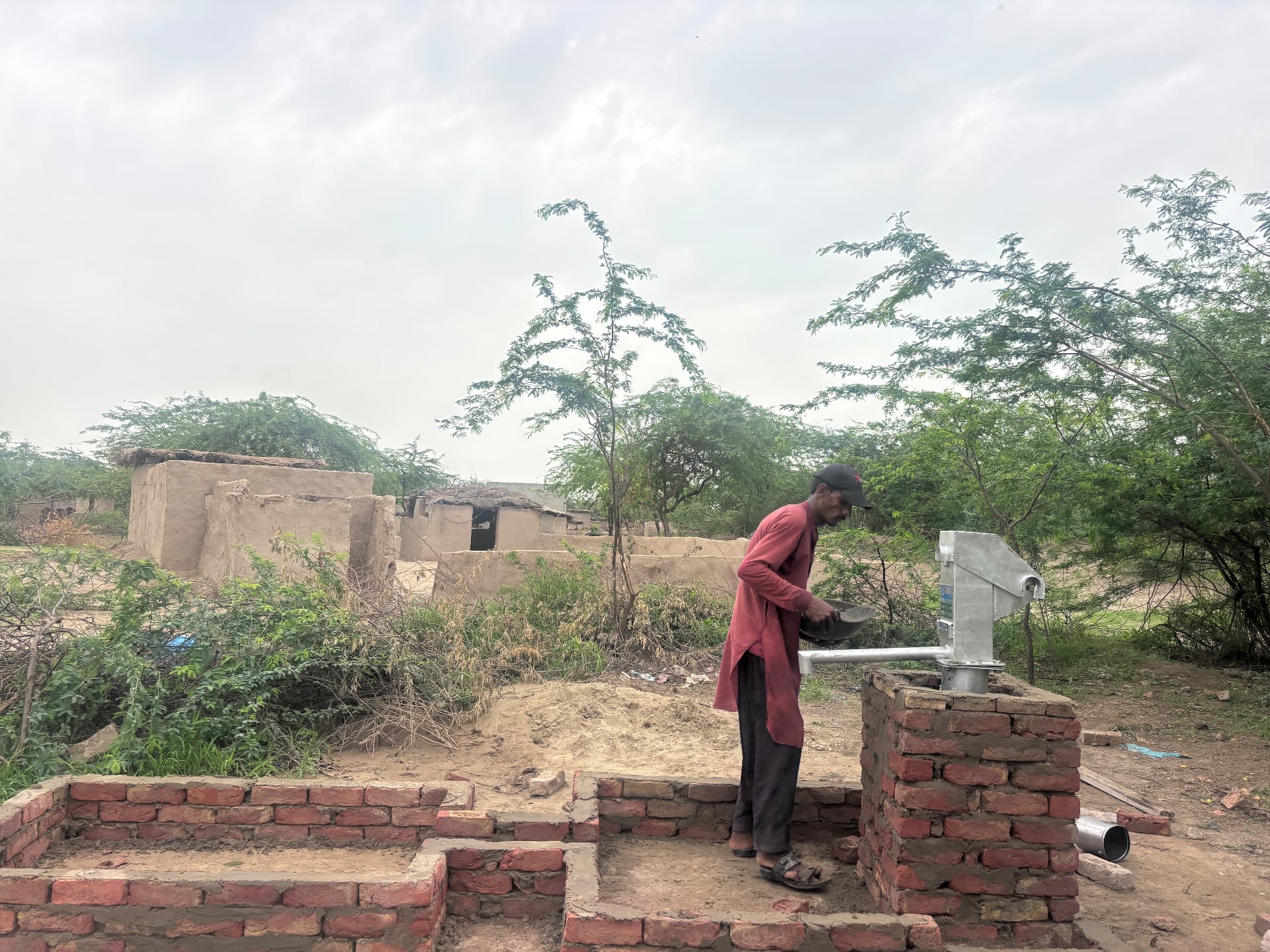 A villager using a newly installed hand pump